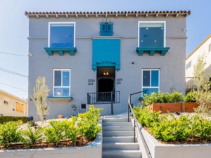 Square multifamily home with bright blue windows